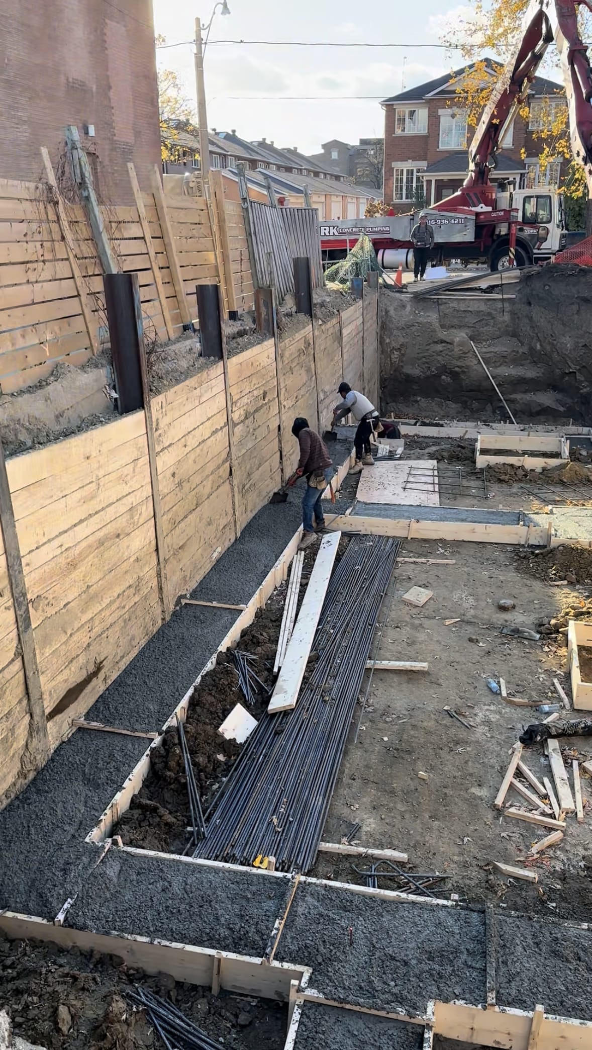 Fresh concrete being poured into foundation footings for Toronto residential project
