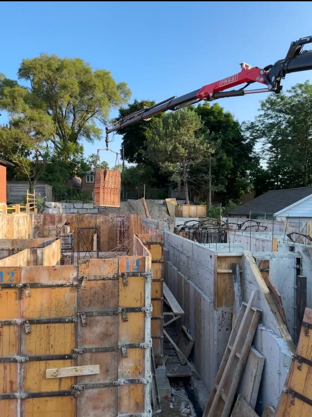 Active concrete pouring operations for assembled foundation walls in Toronto residential project