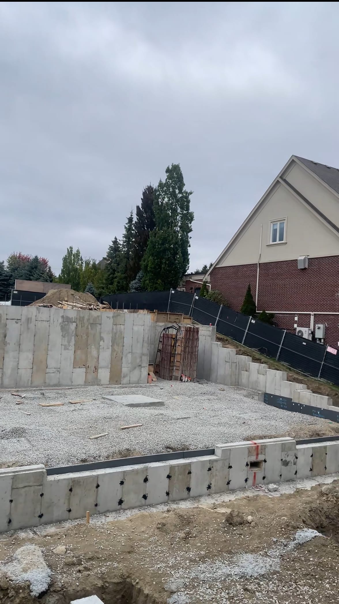 Vaughan residential foundation with fresh concrete walls and waterproofing application in progress