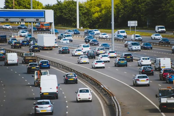 English motorway with busy traffic and road signs