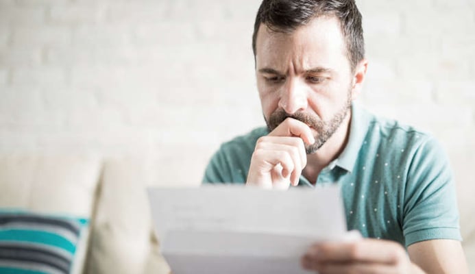 Concerned man reading letter