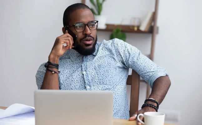 Man on phone with solicitor discussing legal fees