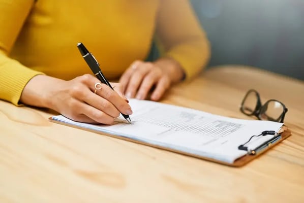 Woman signing a disclaimer form