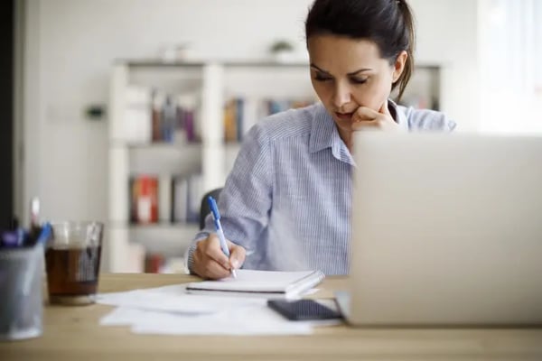 Woman sitting in front of laptop