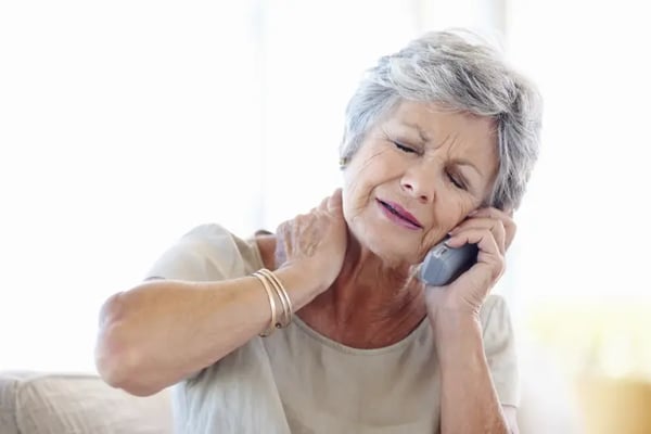 Woman on phone with neck pain