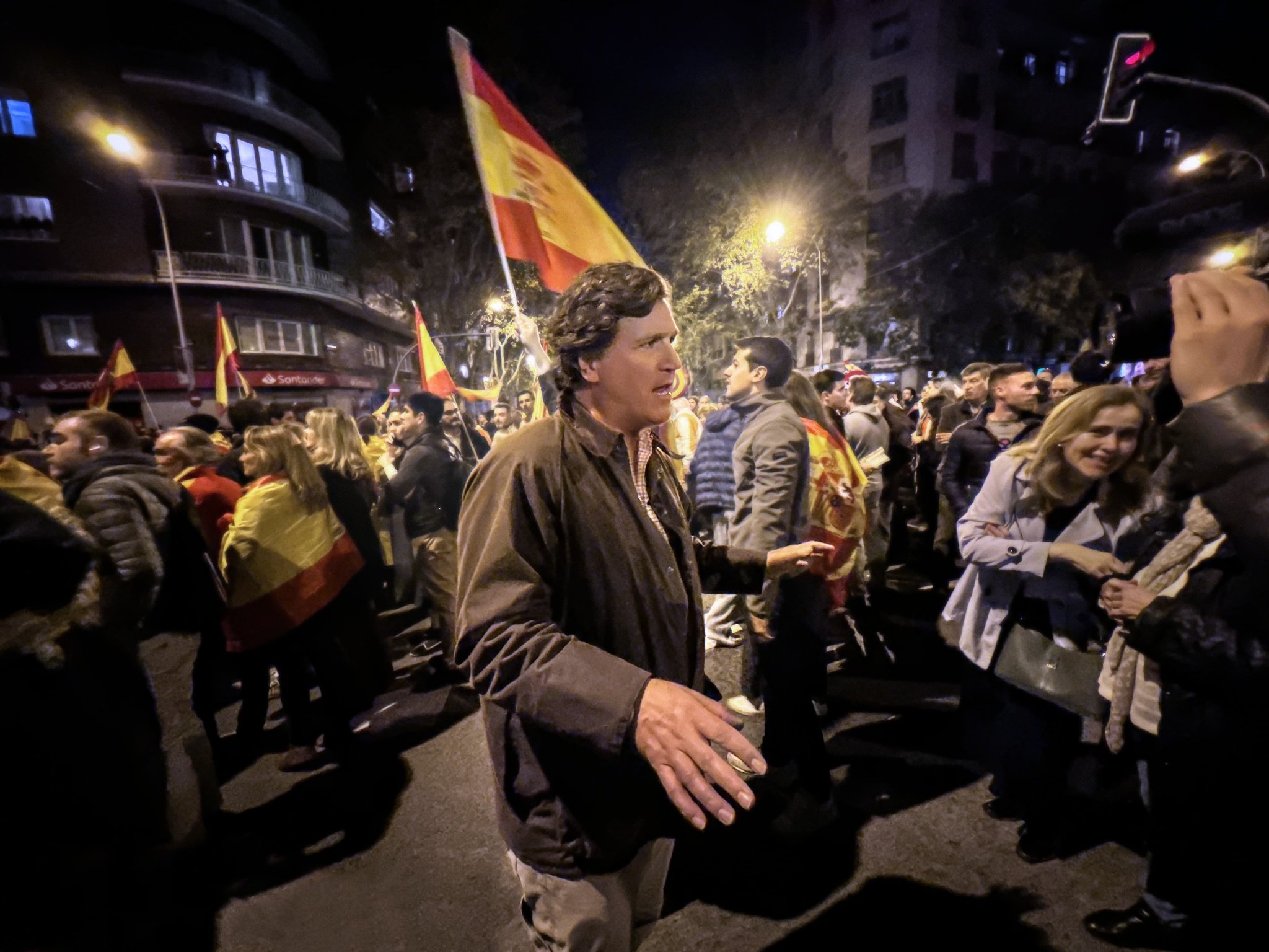 A photo of Tucker Carlson speaking in the crowd