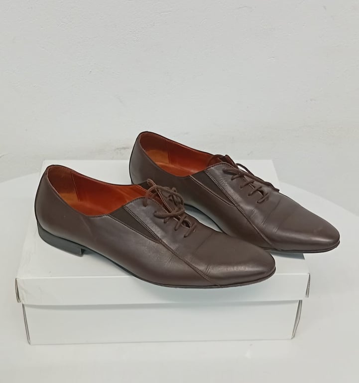 A Pair Of Brown Leather Lace-up Shoes