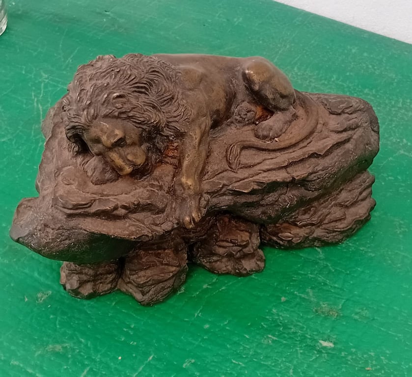 Bronze sculpture of a resting lion