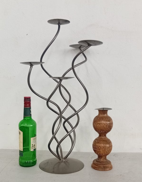A contemporary metal candelabra / candle holder