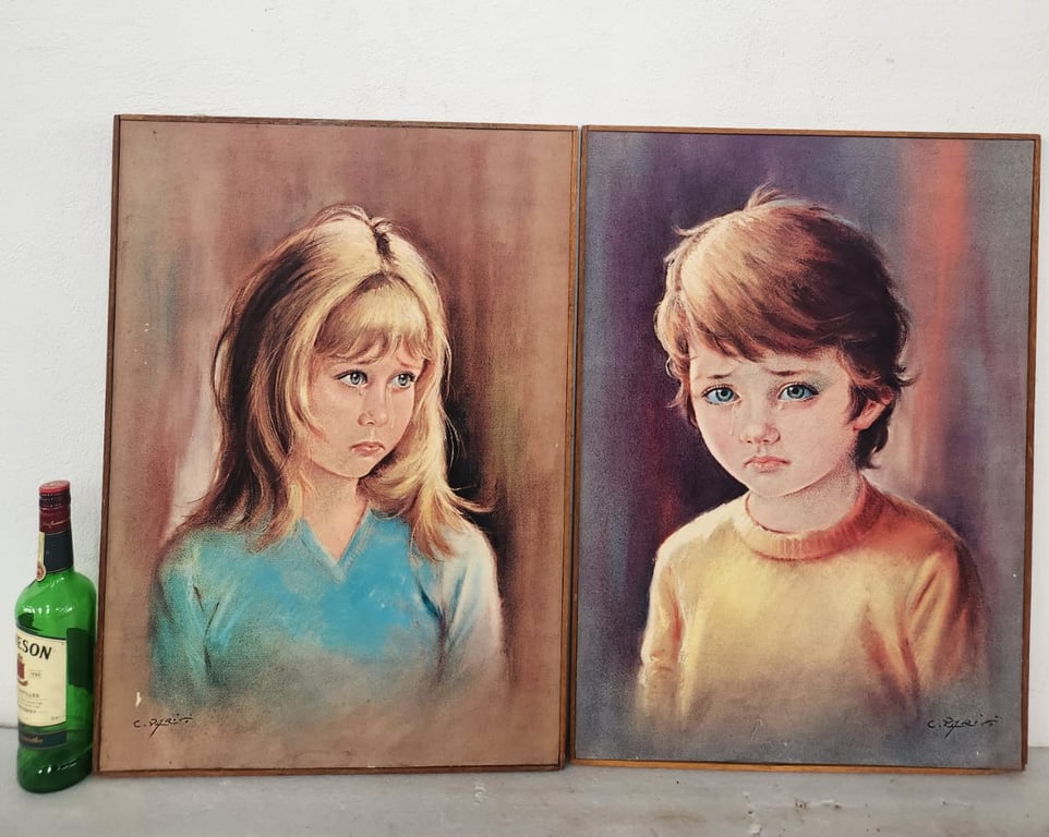 A pair of framed prints known as "The Crying Boy" and "The Crying Girl"