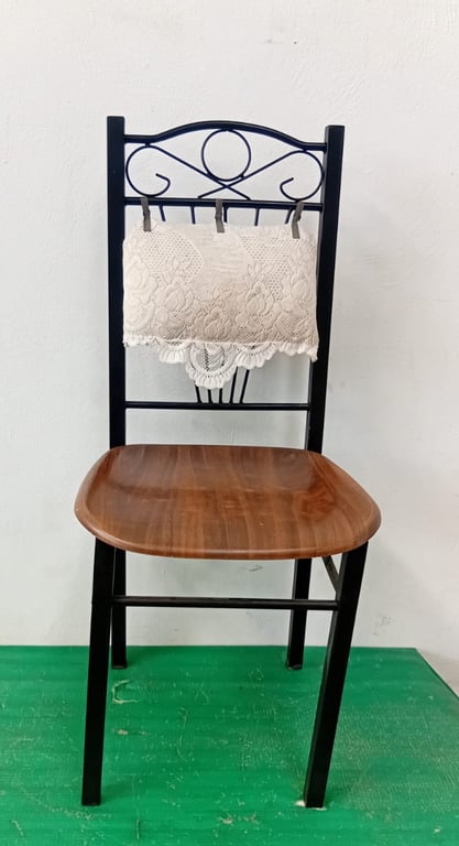 Black metal dining chair with brown wooden seat