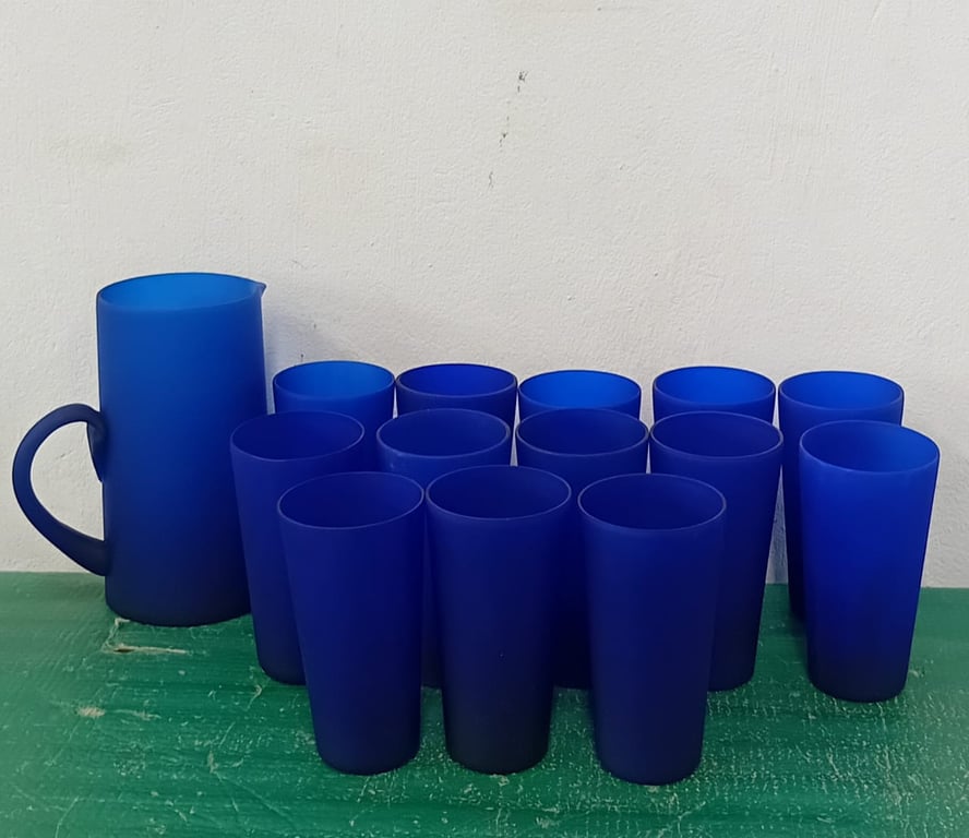 A set of blue frosted glass tumblers and a matching pitcher