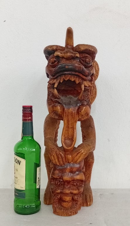 A Chinese-inspired carved wooden dragon totem