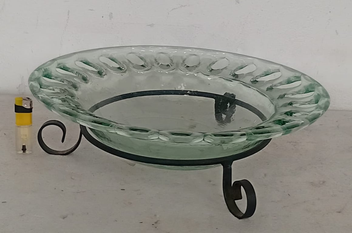Decorative glass serving bowl on a wrought-iron style stand