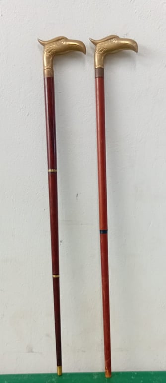 2 X Decorative walking canes featuring bird-shaped brass handle