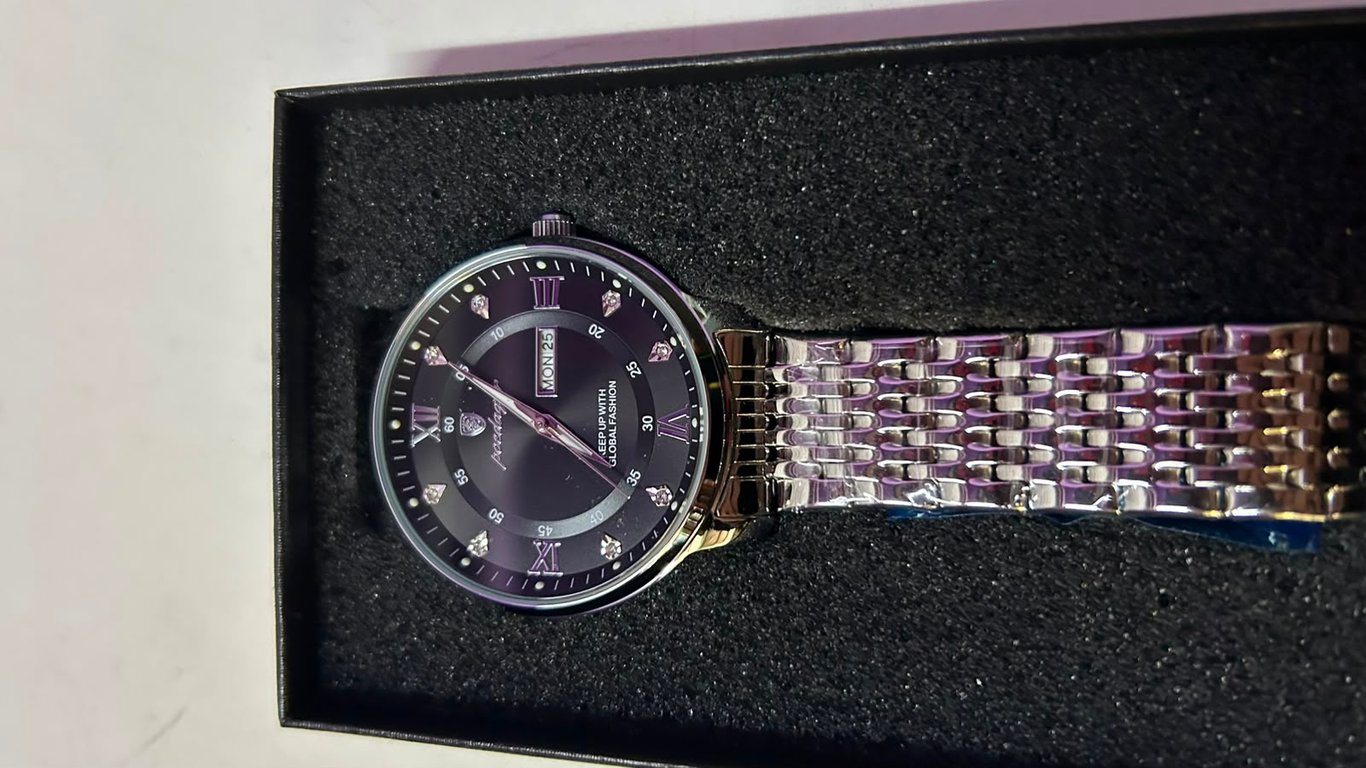 Poedagar watch features a stainless steel bracelet a date calendar and diamond like markers