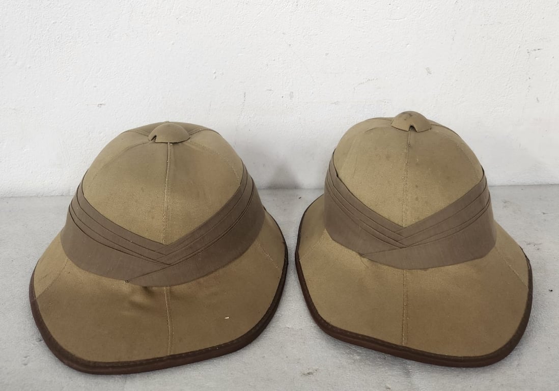 A pair of Wolseley pattern pith helmets (sun helmets)