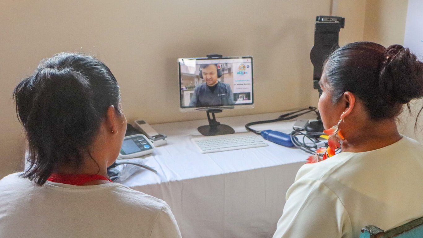 Healthcare workers conducting a remote telemedicine consultation via video call representing Peplink healthcare case studies.