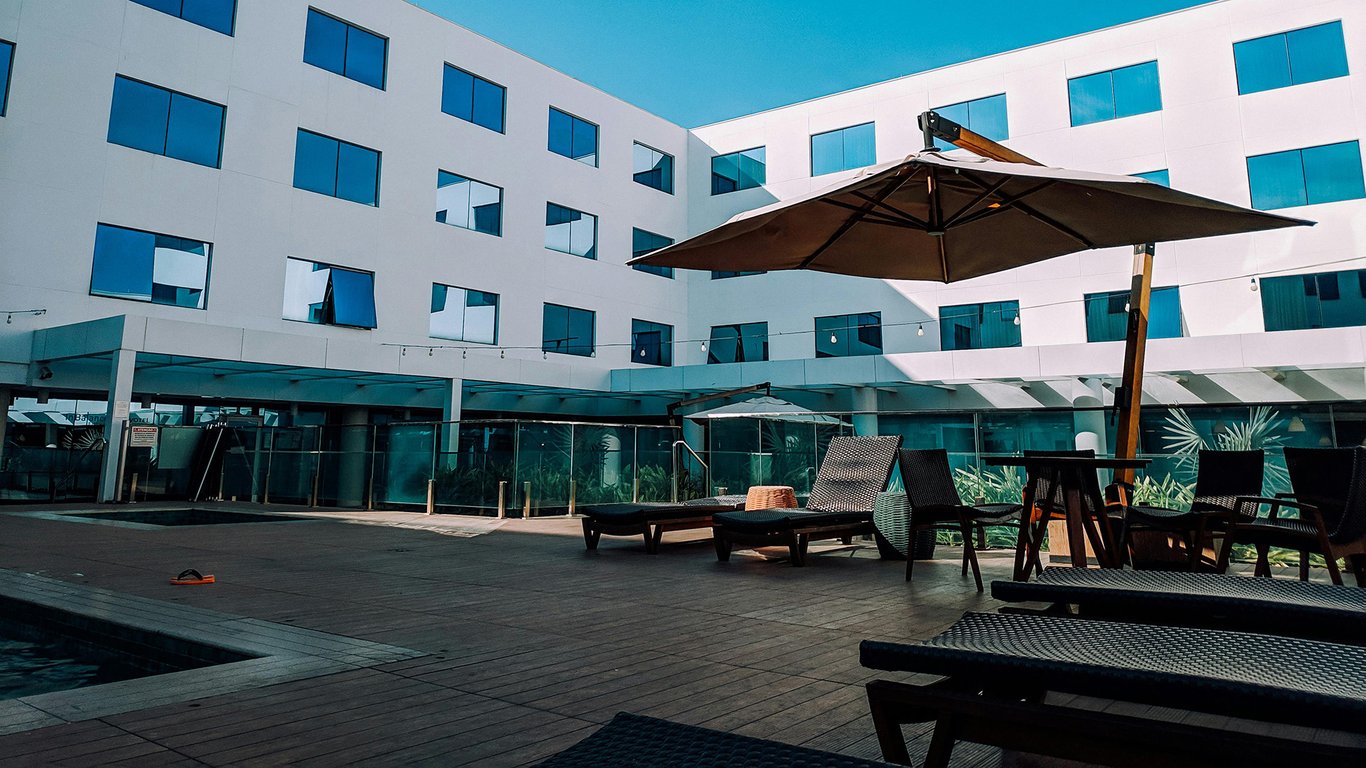 Hotel outdoor terrace with poolside seating representing Peplink hospitality connectivity solutions.