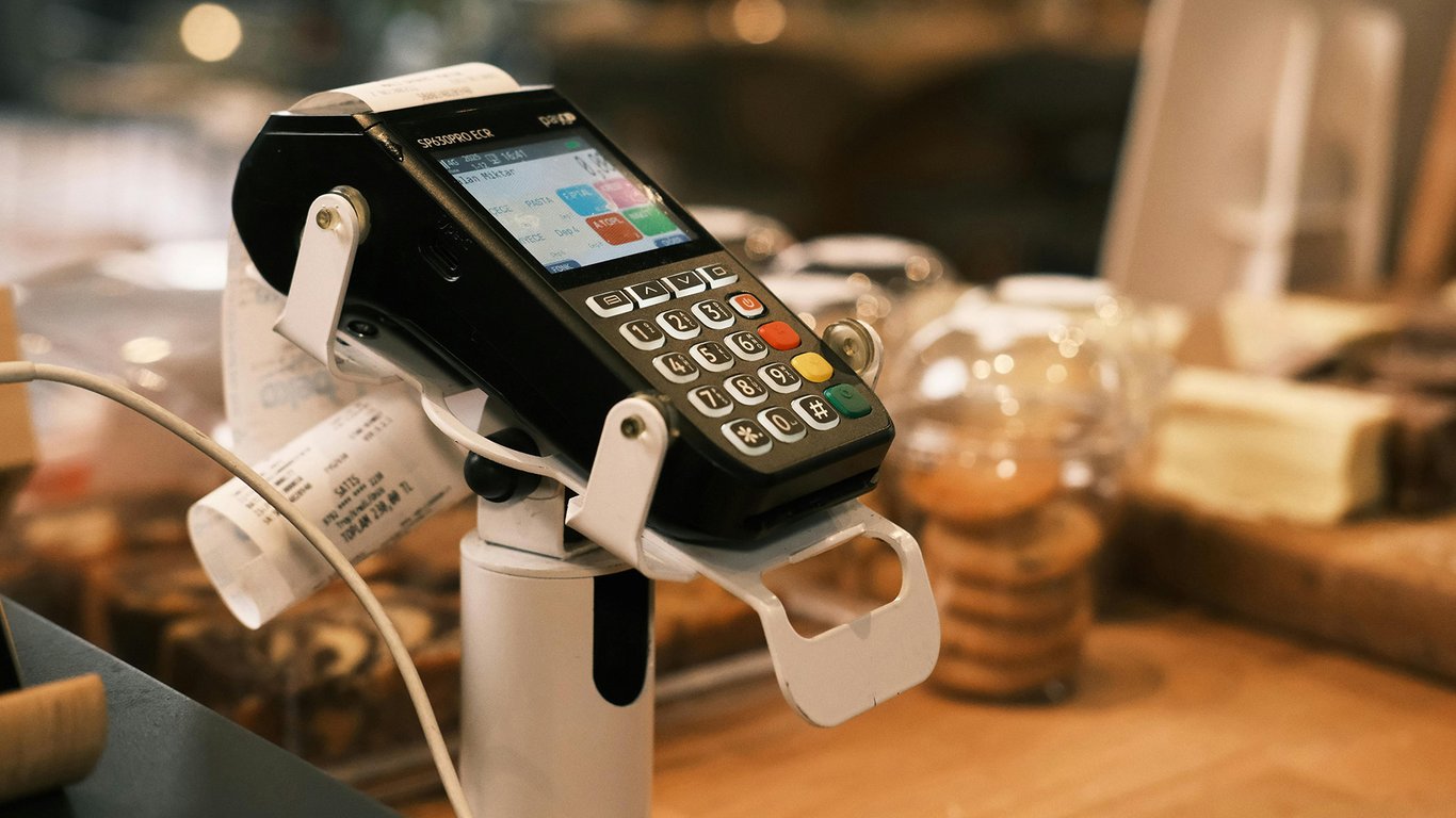 POS payment terminal on a retail counter representing Peplink retail connectivity solutions.