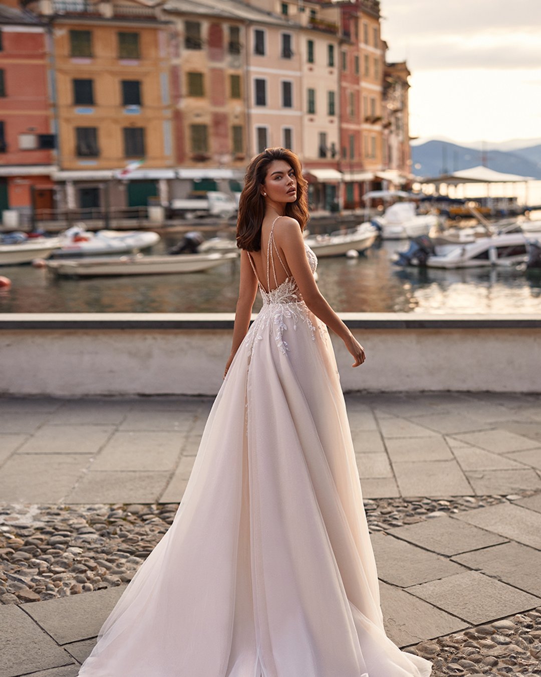 Anna Sposa – Model Varma to lekka suknia A-line z ręcznie zdobioną koronką, subtelnym rozcięciem i delikatnym trenem. Romantyzm i elegancja w jednym!