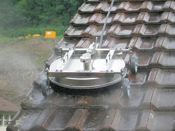 Detail View of Roof Cleaner Cleaning Tiled Roof