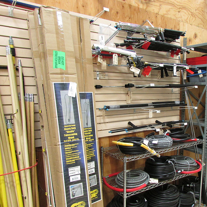 Wands and hoses displayed on wall