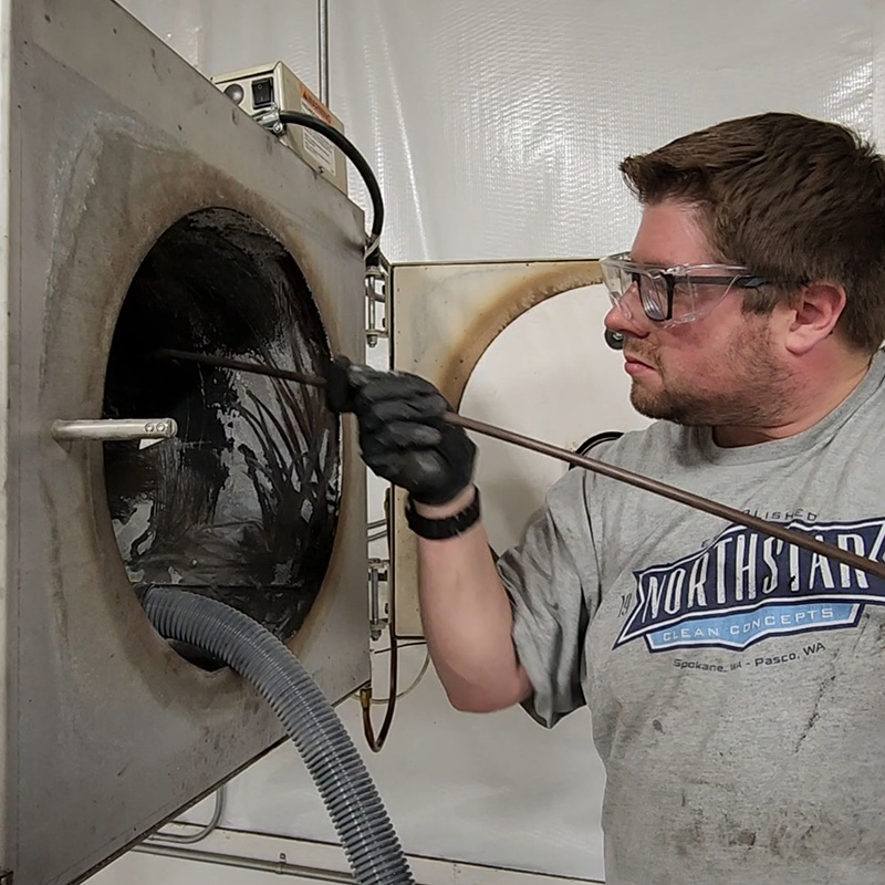 Northstar technician cleaning out a combustion chamber