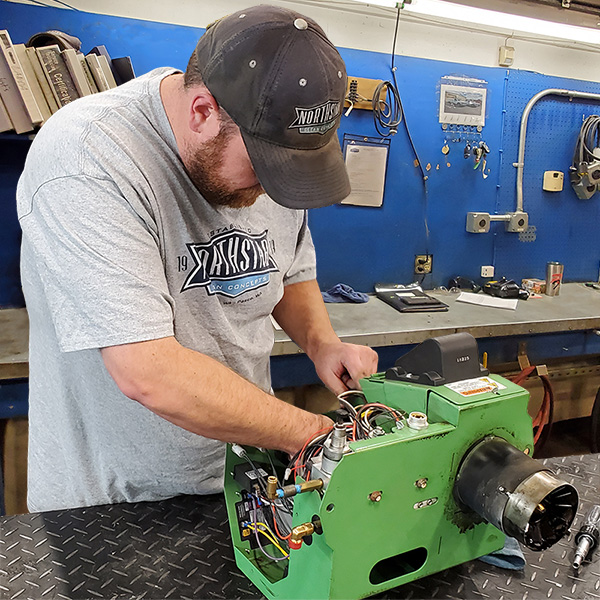 Northstar technician preforming maintenance on a waste oil burner