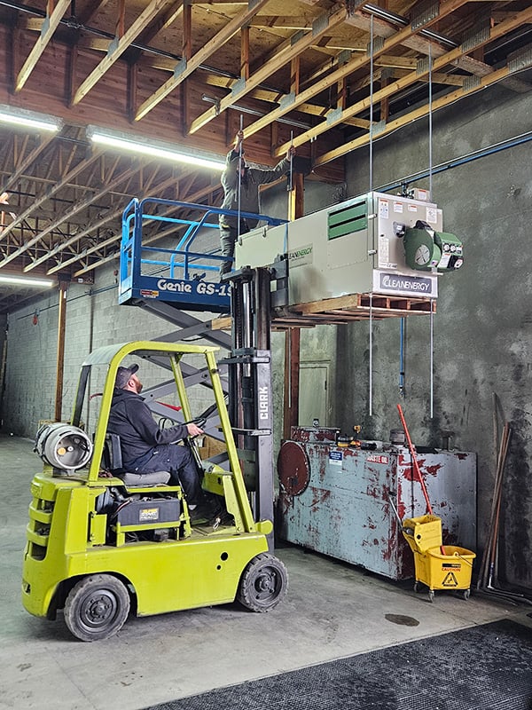 Northstar Technicians Mounting a Waste Oil Heater to Shop Ceiling