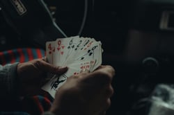 Close-up shot of hands holding a deck of playing cards inside a carevoking a sense of intrigue.