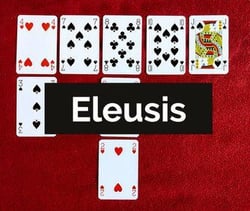 deck of cards setup for a game of eleusis on red felt