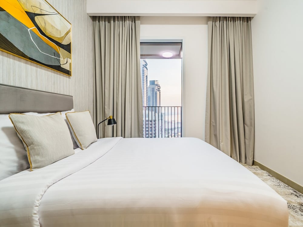 Second bedroom with a king bed and a balcony