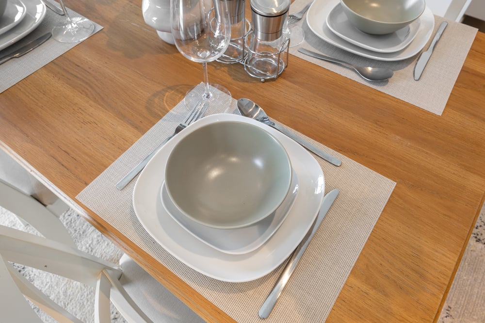 Close-up of dining table place setting with bowl and cutlery