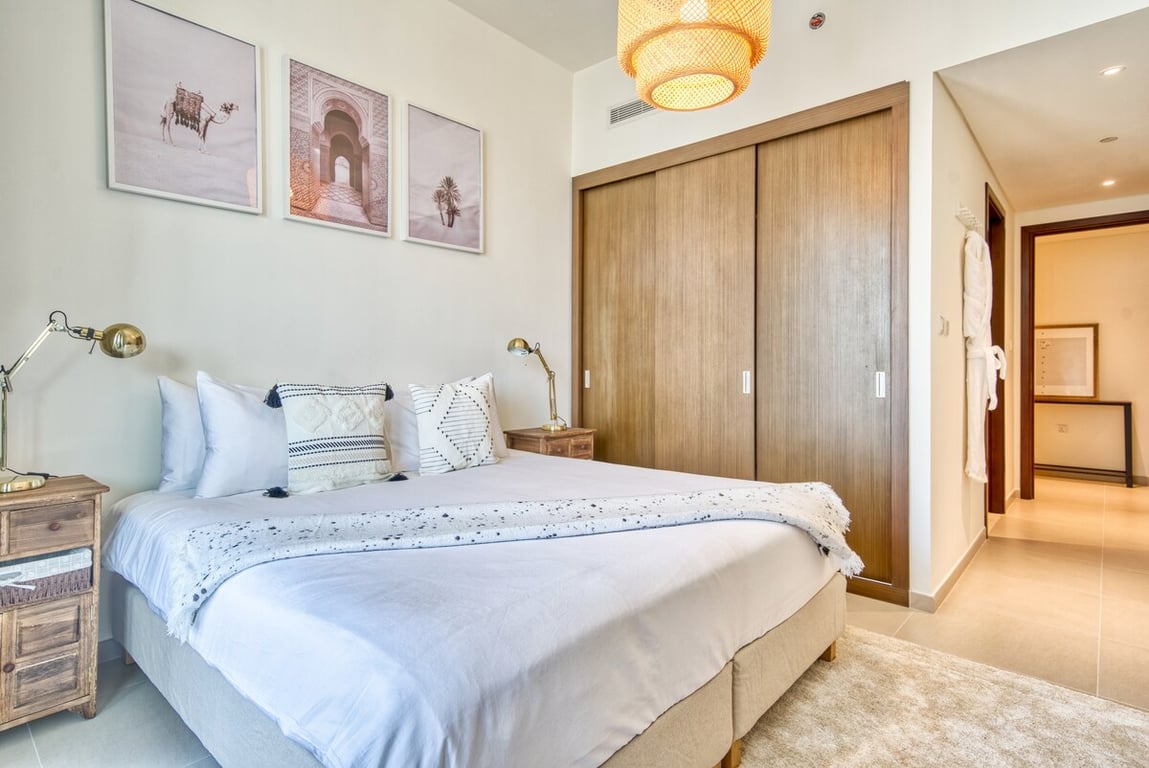 Bedroom with king bed, wall art and sliding wardrobe