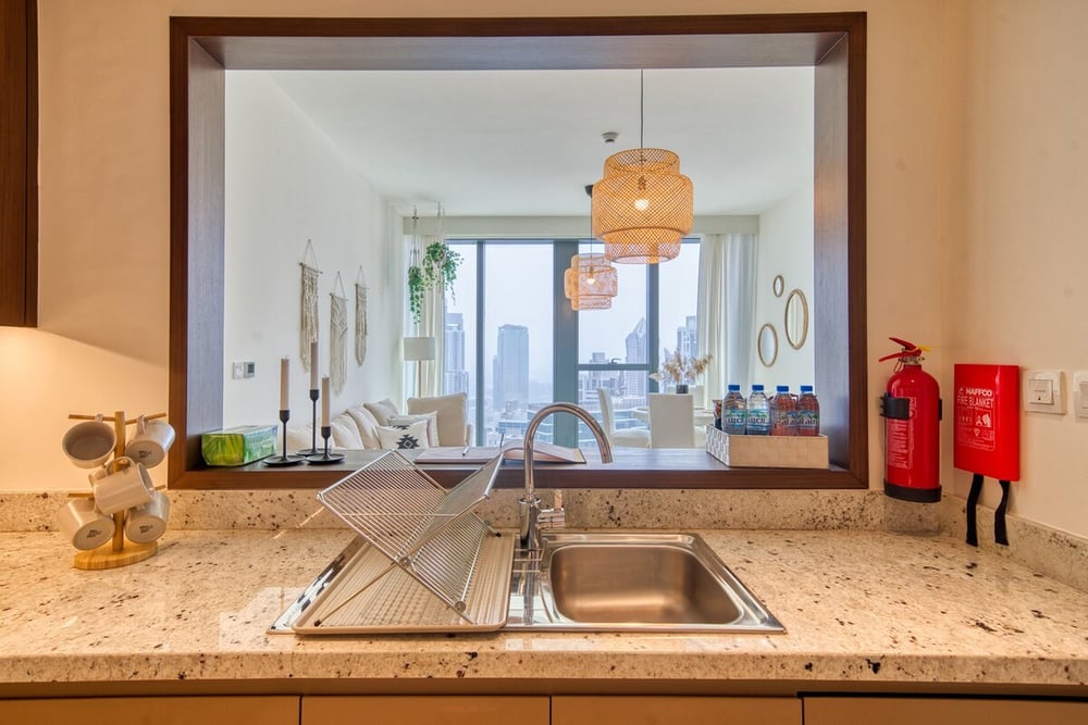 Kitchen pass-through window with sink and fire extinguisher