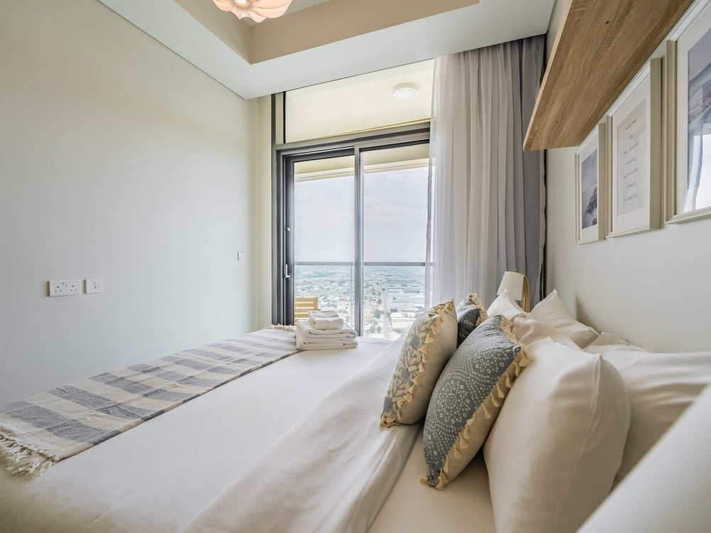 Bedroom with double bed and floor-to-ceiling window panoramic view
