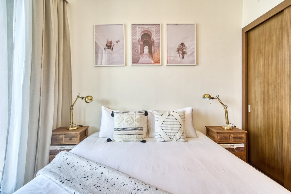 Bedroom with king bed, nightstands and wall art