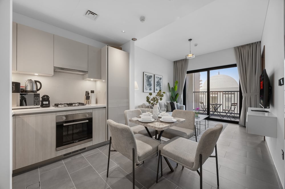 Dining area with table for four and balcony beyond