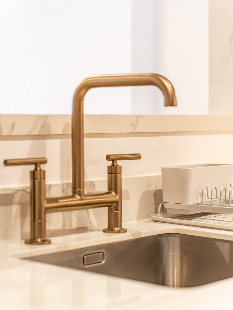 Kitchen sink with brass bridge faucet