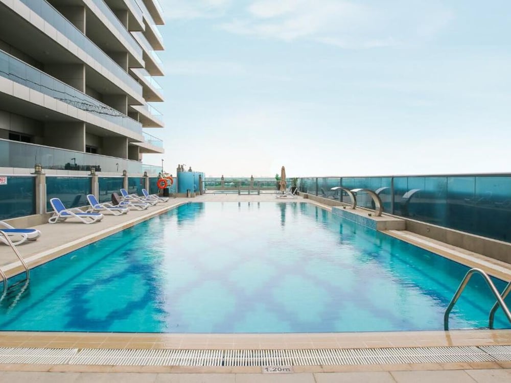 Rooftop infinity pool with sun loungers