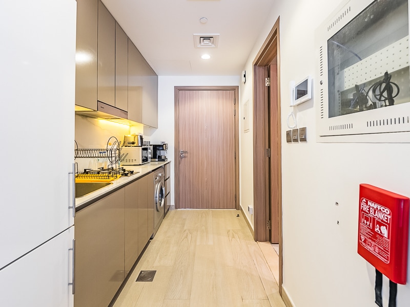 Studio kitchen corridor with fire extinguisher on wall