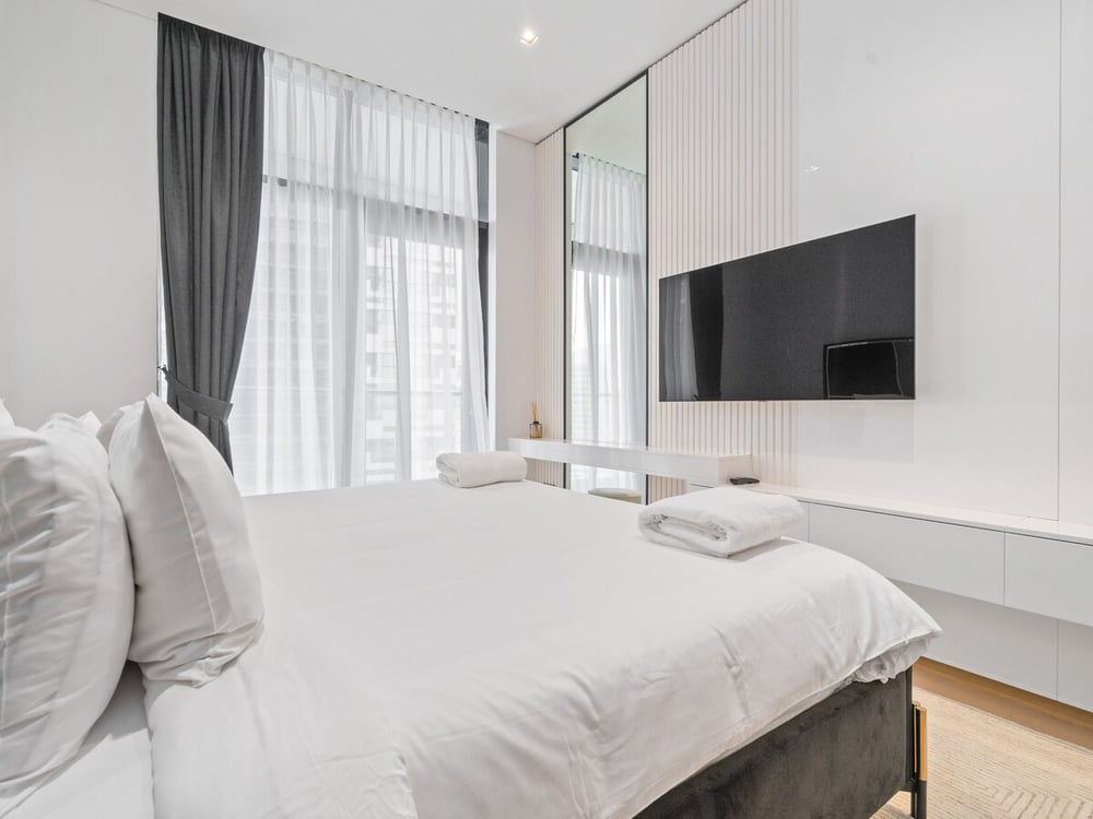 Bedroom with king bed and wall-mounted TV
