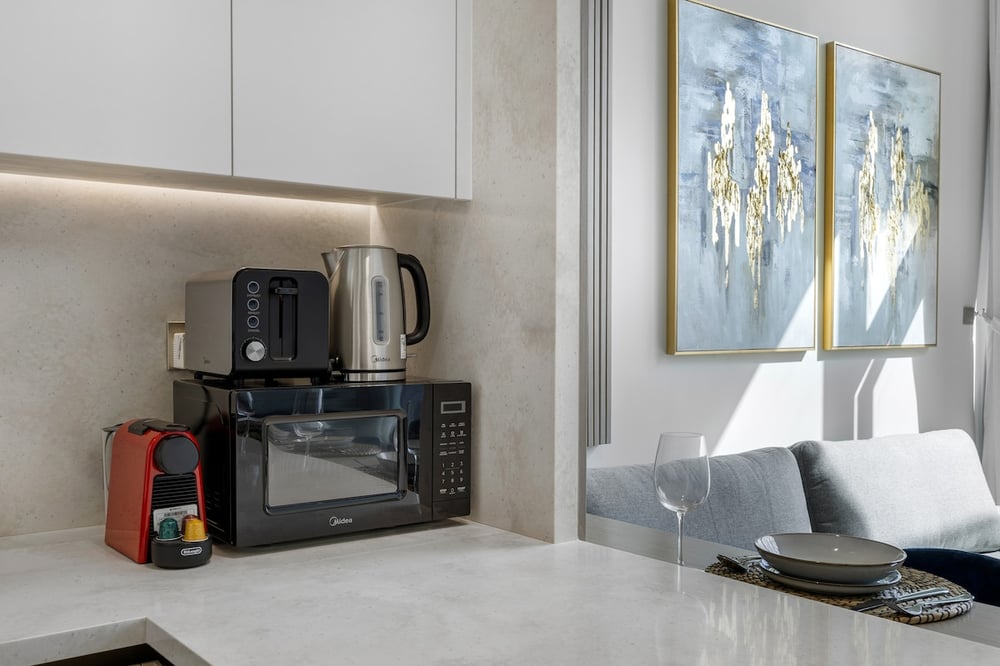 Kitchen counter with microwave, kettle and coffee machine