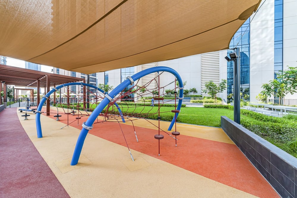 Outdoor childrens playground with swings and climbing structure