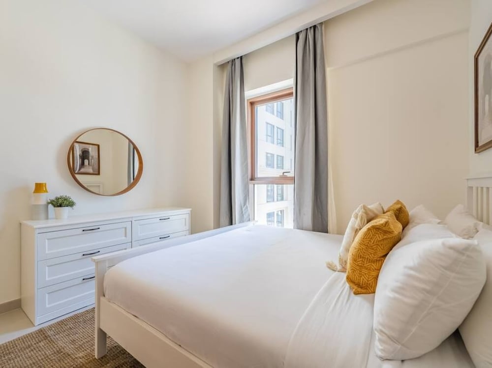 Bedroom with double bed dresser mirror and balcony