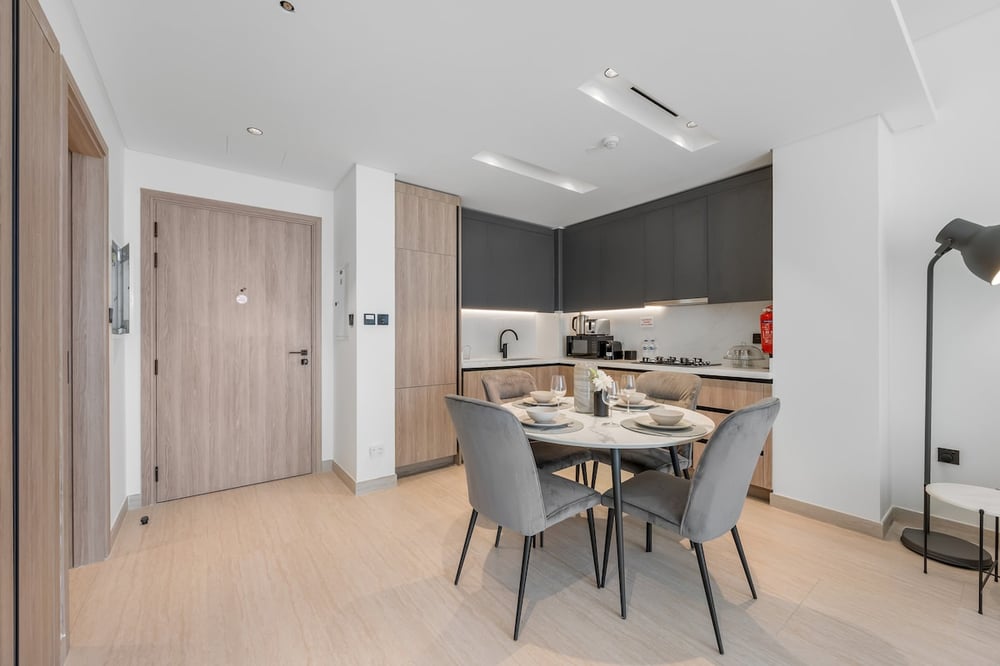 Dining area and kitchen with entry door visible