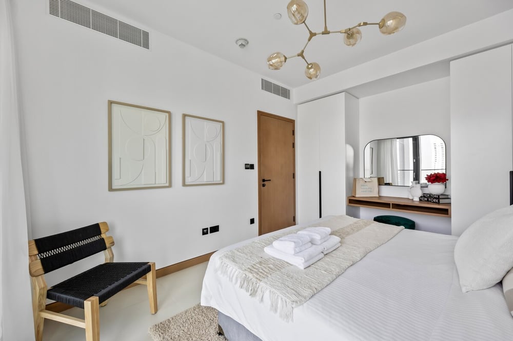Second bedroom with double bed and artwork on wall