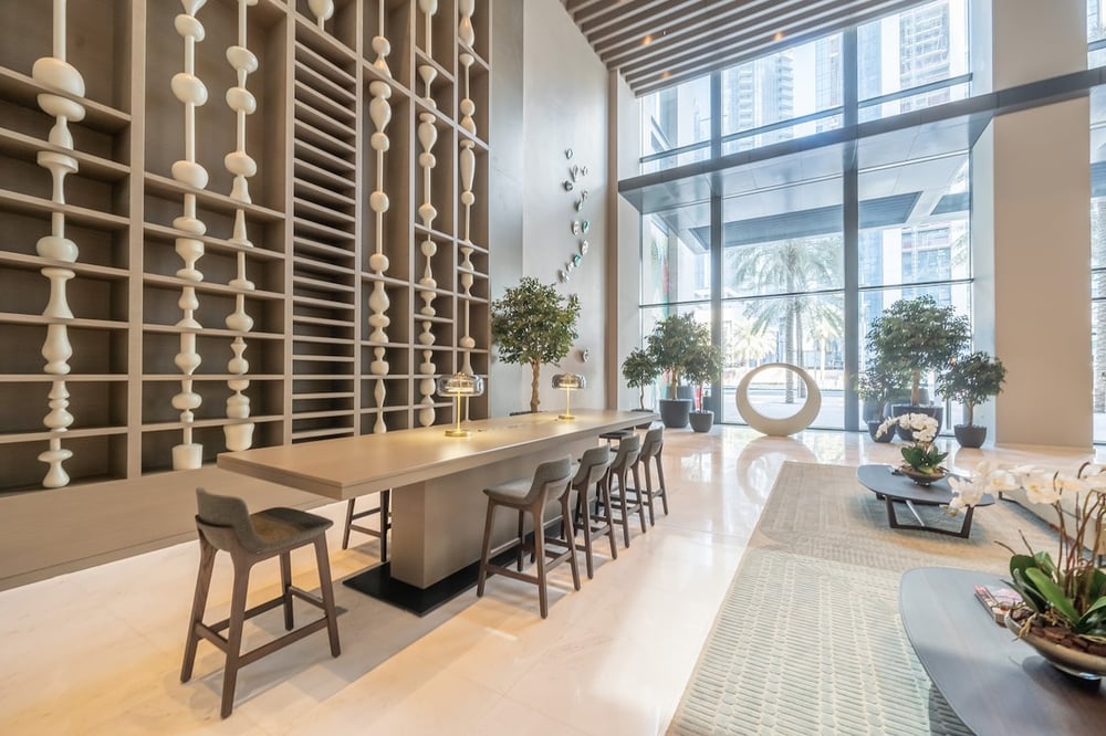 Building common area with high bar table and wine rack wall