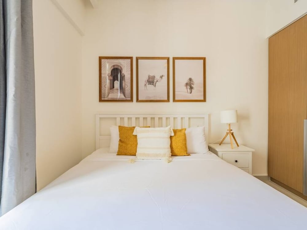 Bedroom with double bed framed wall art and nightstand